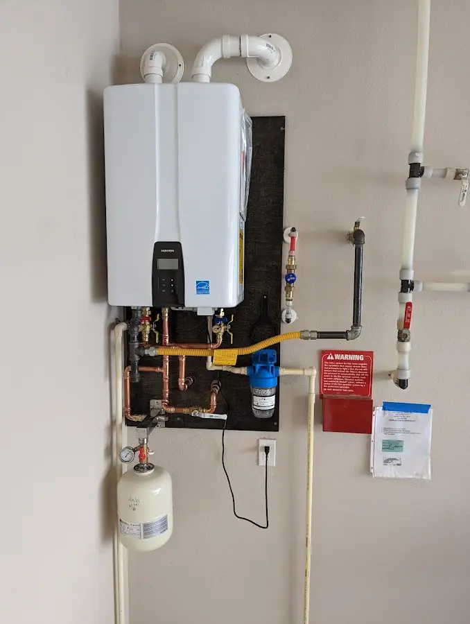 Professional plumber installing copper piping in a Upper Allen home